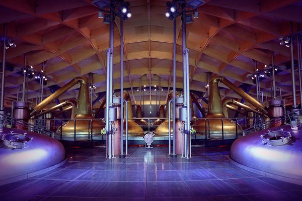 Spirit stills inside The Macallan distillery's modern timber-roofed production hall, Speyside