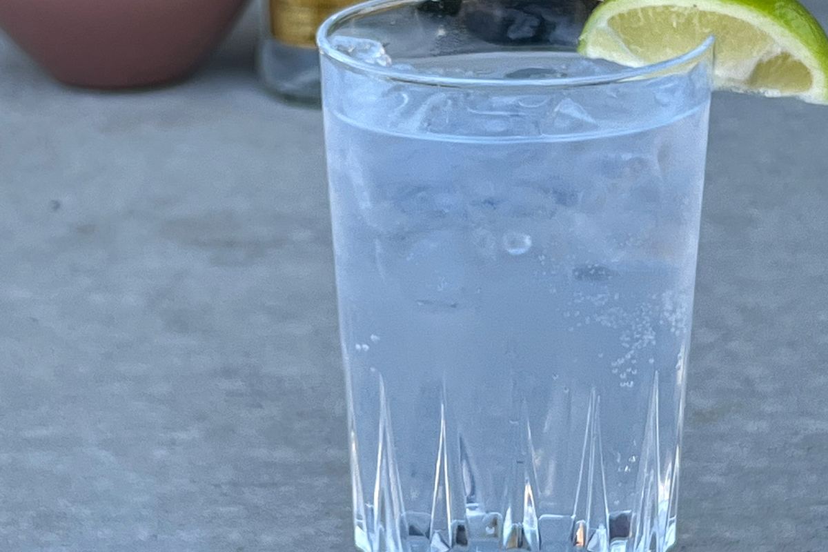 Tall highball glass filled with ice and soda