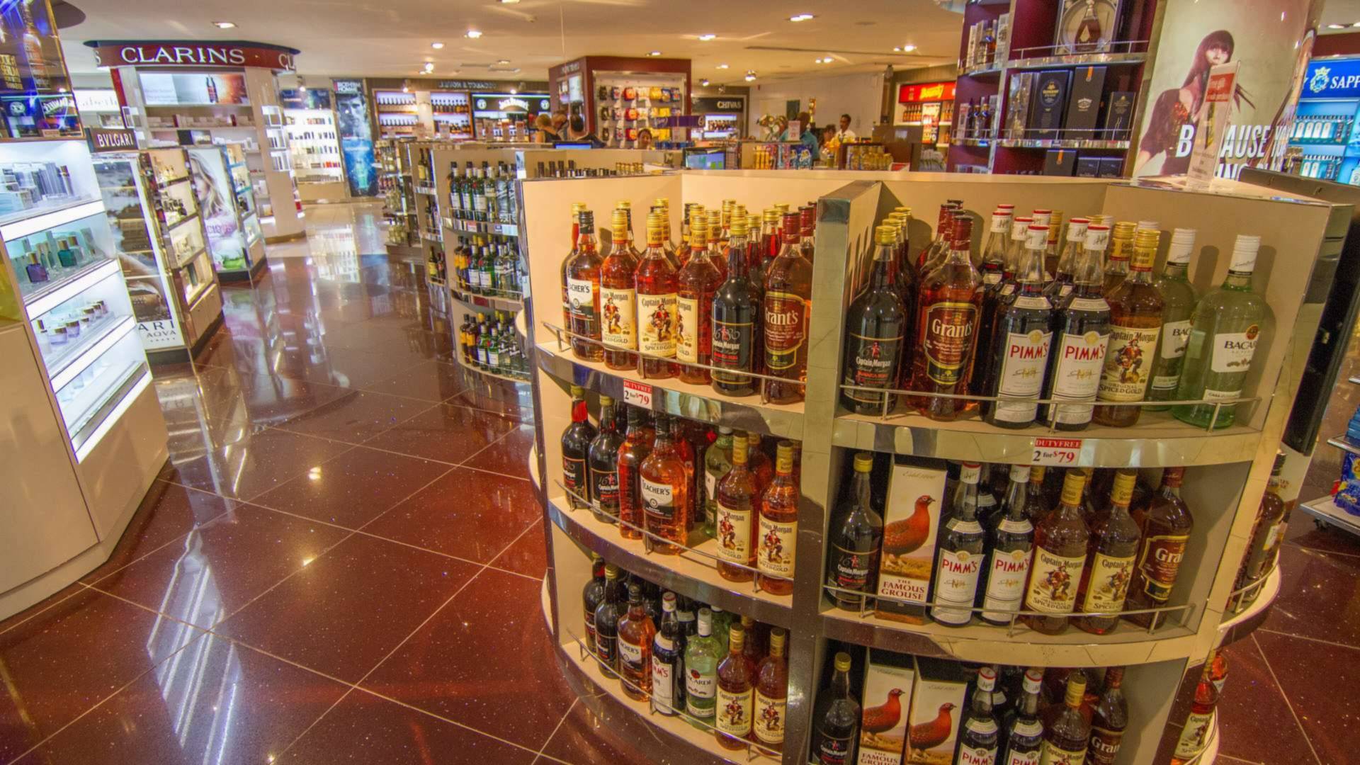 Airport duty-free shop with stands of whisky bottles, for our duty free whisky Malaysia guide