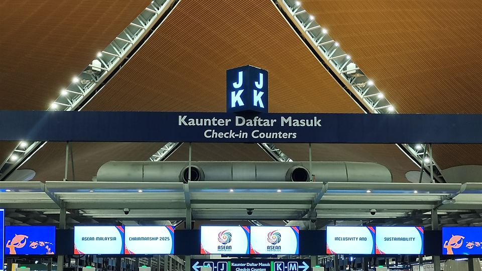 Check-in hall at KLIA Terminal 1 with its timber roof and check-in counters