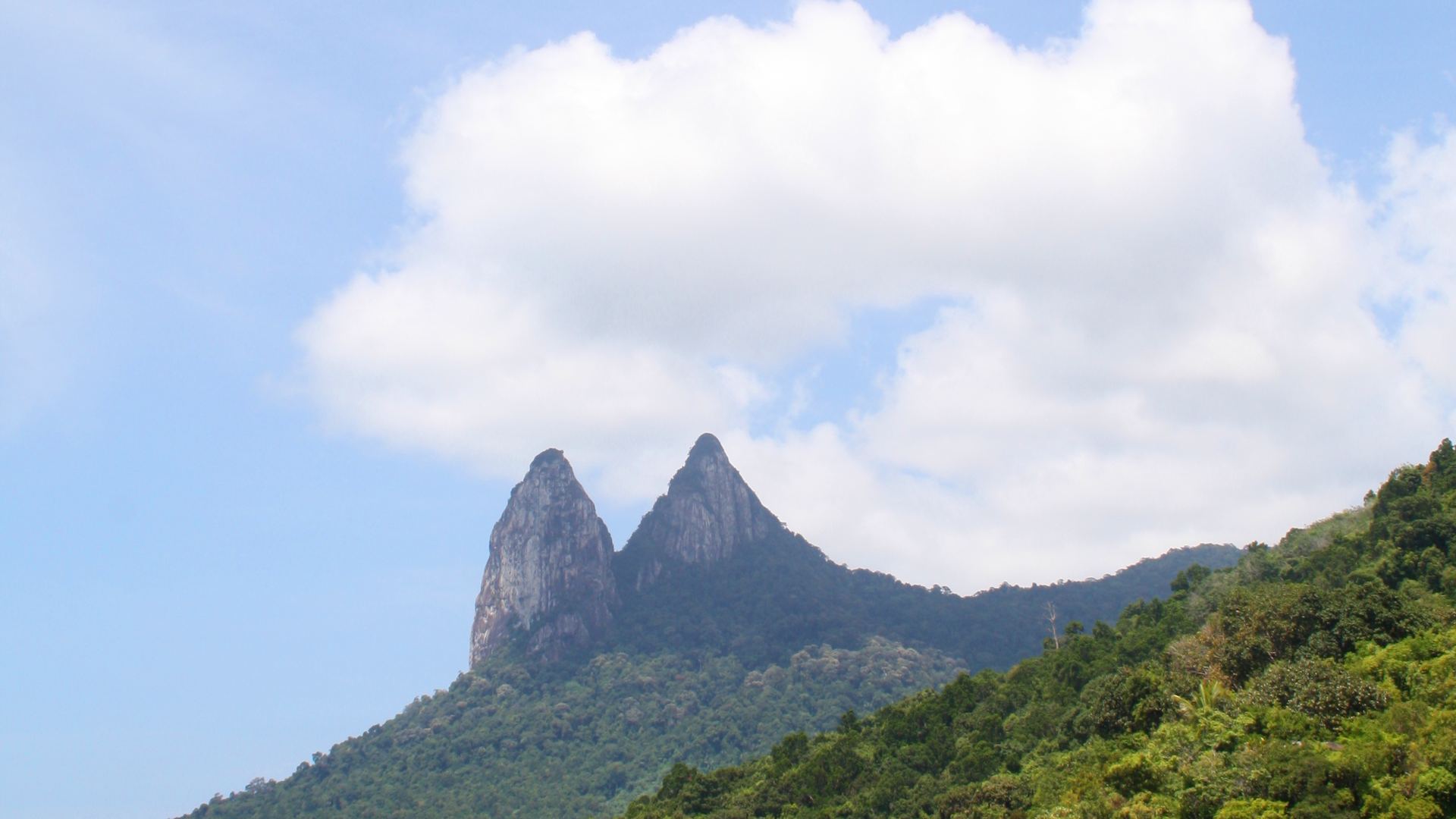 Twin peaks of Tioman island above the sea, for our Tioman duty free whisky guide
