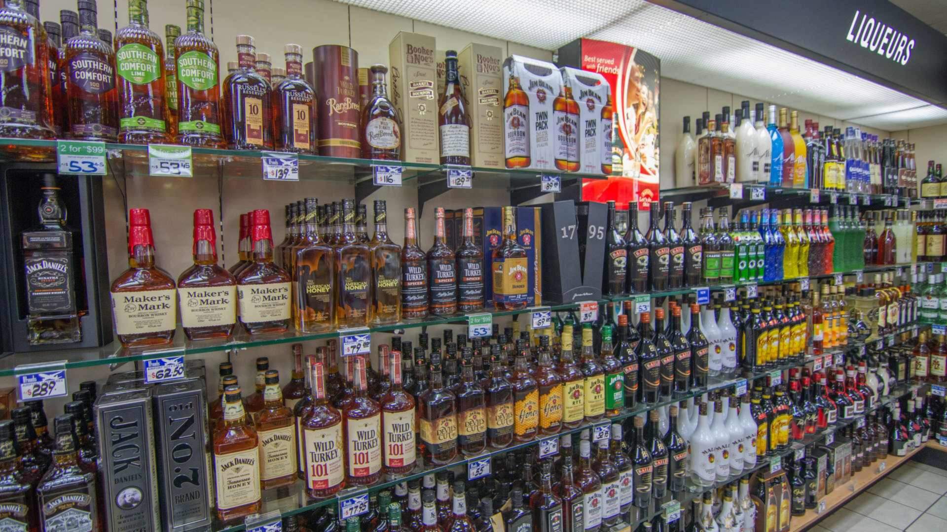 Shelves stocked with whisky bottles, illustrating where to buy whisky safely in Malaysia