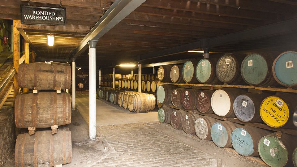 Rows of whisky casks resting in a bonded warehouse at Strathisla Distillery